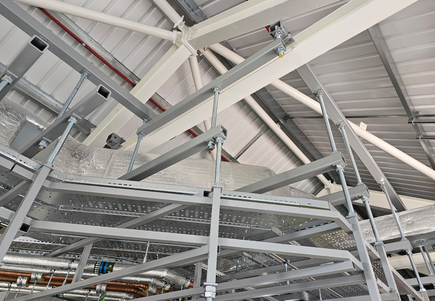 A second view of fire-resistant custom steel support modules carrying building services.