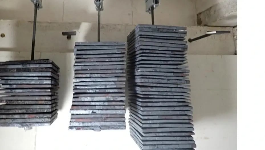 A trapeze support under test with suspended weight stacks